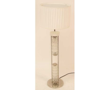 A 1970s chrome and moulded clear glass floor lamp, having a pleated cylindrical shade, upper and lower moulded glass detail, 