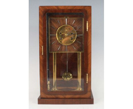 An Art Deco mahogany cased four-glass mantel clock, having a square dial with baton markers, visible escapement, spring-drive