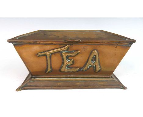 An Arts &amp; Crafts copper tea caddy, of sarcophagus form, the hinged cover enclosing twin division interior, the front embo