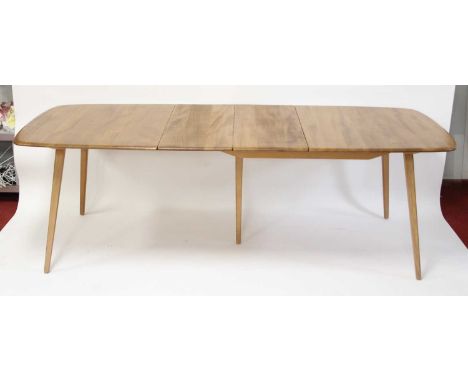 A 1960s Ercol light elm extending dining table, having rounded D-ends, pull-out action and single folding drop-in leaf, with 