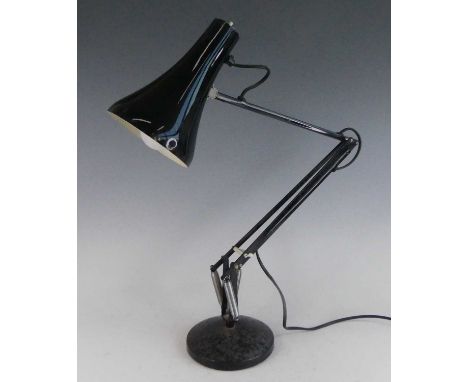 A mid-20th century black painted anglepoise lamp, of hinged and rotating form, with moveable shade, raised on a slightly dome