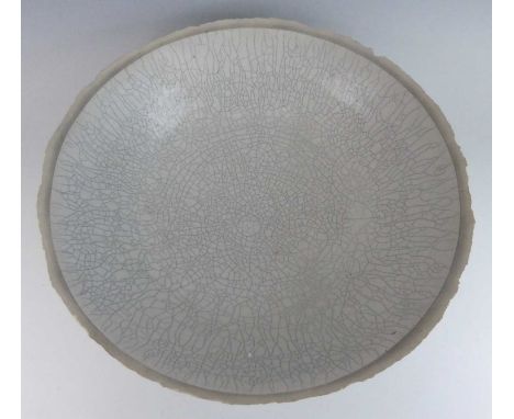 In the style of Lucie Rie - a large crackle glazed studio pottery table bowl, of circular wok form, indistinct artists monogr