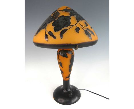 After Émile Gallé - a large cameo glass table lamp, the shade of mushroom form, with typical raised floral stylised decoratio