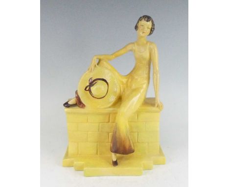 A 1930s Wade Pottery painted ceramic figure titled Sadie 3, modelled as a seated young woman upon a wall holding a summer hat