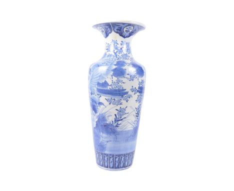 A large 20th century Chinese floor standing blue and white Kangxi vase. The base of bulbous form with peony tree decoration a