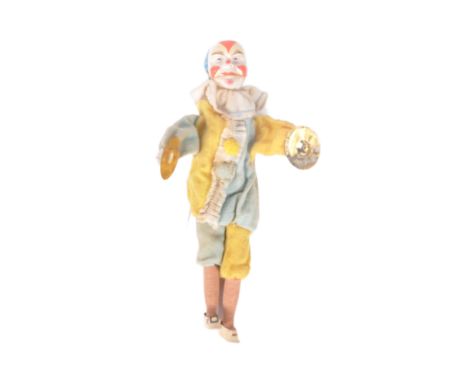 An early 20th Century Chinese cymbal playing clown toy doll. Papier mache / plaster head with painted details, brass cymbals,