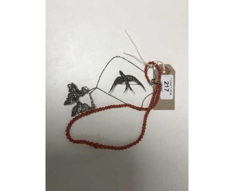 A silver marcasite necklace, together with a similar brooch and an antique coral necklace. (3)