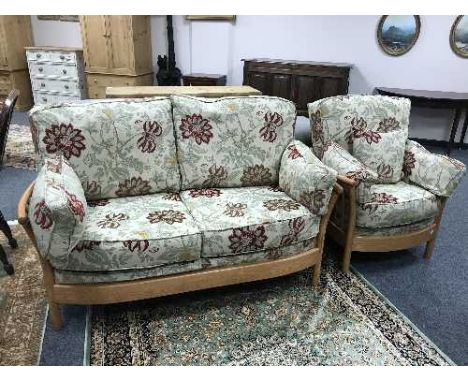 An Ercol two seater settee and matching armchair with floral cushions (2)