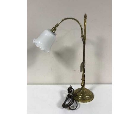 A rise and fall brass table lamp with white glass shade