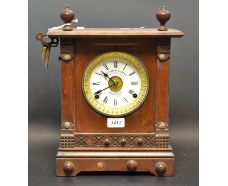 An early 20th century stained oak mantel clock, white enamel dial, c.1920