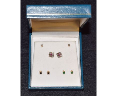 A pair of 9ct gold four-in-one interchangeable diamond, emerald, ruby and sapphire earrings, cased