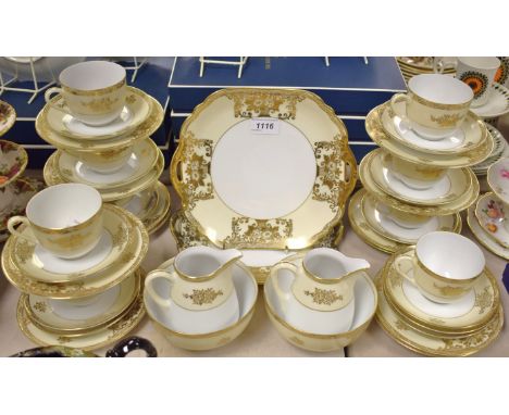 A gilt tea service made in Japan comprising a pair of bread plates, cream jugs, sugar bowls, tea plates, cups and saucers.