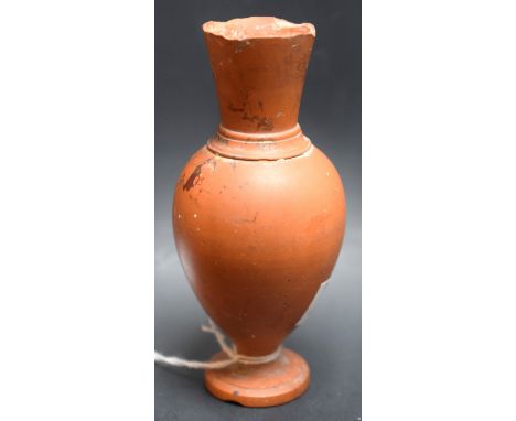 A post-Medieval miniature terracotta baluster vase, the shoulder with girdle, spreading circular base, 11cm high 