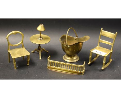 Brass Miniatures - A balloon backed chair; a tilt top tripod table; a helmet shaped coal scuttle; a table lamp; a fender; a r