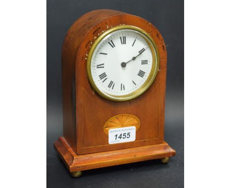 An Edwardian mahogany domed mantle clock, white dial, roman numerals, inlaid with a satinwood fan shaped cartouche,brass bun 