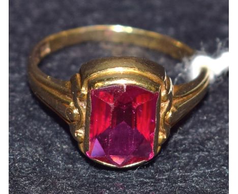 A simulated ruby and 8ct gold dress ring, rounded bagutte stone, 8ct gold shank, stamped 333, 2.5g gross