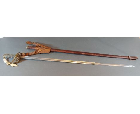 A Victorian officer sword with brass hilt and leather scabbard, length of blade 82cms long 