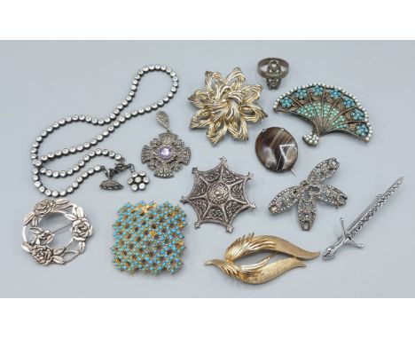 A silver marquasite pendant in the form of a cross, together with nine brooches, a paste set necklace and a silver ring 
