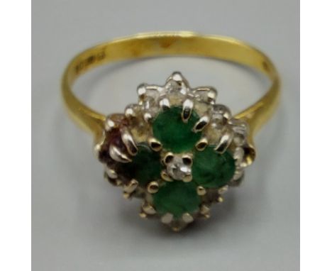 A 18ct yellow gold emerald and diamond cluster ring set four emeralds surrounded by diamonds within a pierced setting, ring s