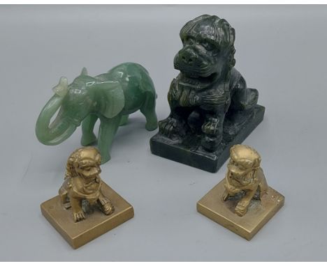 A pair of Chinese brass seals in the form of Dogs Of Fo together with a jade model of an elephant and a hardstone model in th