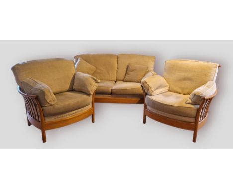 An Ercol Renaissance three piece suite comprising a two seat sofa and a pair of matching armchairs 