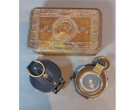 A Queen Mary Christmas tin together with a first world war brass compass by S. Mordan and Co. and a bakelite compass 
