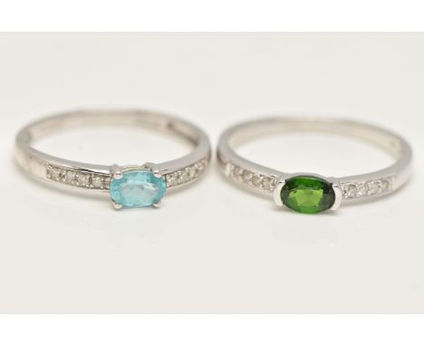 TWO 9CT GOLD GEM SET RINGS, a pair of matching white gold rings, one set with an oval cut blue stone, the other set with an o