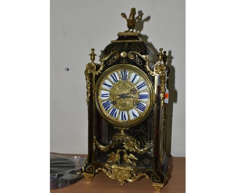 A FRENCH BOULLE NINETEENTH-CENTURY MANTEL CLOCK fitted in an elaborate brass inlaid case with a cast dial with blue Roman num