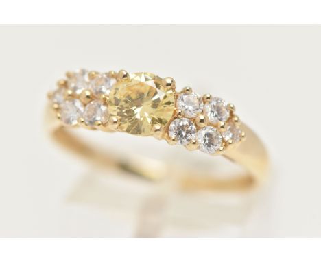 A 14CT GOLD CLUSTER RING, set with a circular cut yellow cubic zirconia and ten circular cut colourless cubic zirconia, yello