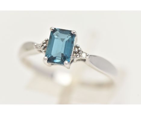 A 9CT GOLD GEM SET RING, a rectangular cut blue topaz, flanked with two single cut diamonds, prong set in white gold, hallmar