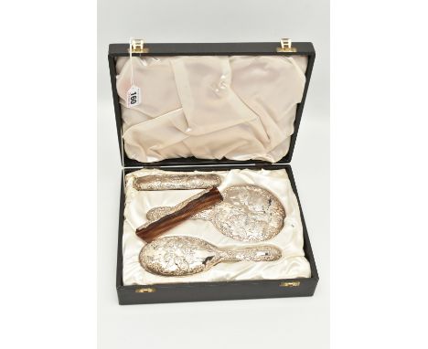 A CASED ELIZABETH II SILVER VANITY SET, embossed cherub and foliate design with vacant cartouche, comprised of a hair brush, 