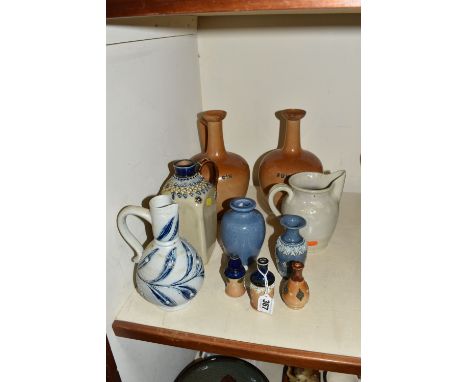 A COLLECTION OF DOULTON LAMBETH STONEWARE ITEMS, comprising a sgraffito jug with blue foliate decoration, 'Gin' and 'Rum' spi