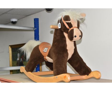 A VINTAGE MAMAS AND PAPAS ROCKING HORSE, a Mamas and Papas child's plush rocking horse with a tan saddle and reins, brown and