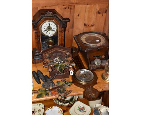 A GROUP OF CLOCKS, comprising a cuckoo clock with weights and pendulum, with cuckoo and guitar player character behind twin d