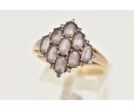 A 9CT GOLD CLUSTER RING, nine oval cut amethyst, prong set with diamond accents, yellow gold shank, hallmarked 9ct Birmingham