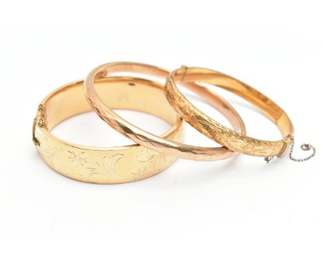 THREE BANGLES, the first a solid bangle with facet detail, stamped 9ct gold bronze core, the second a wide hinged bangle with
