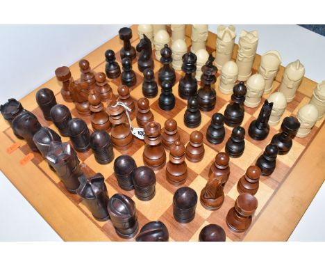 A CHESSBOARD WITH TWO SETS OF CHESS PIECES, to include a Anne Carlton chess set, masked medieval figures on contemporary base