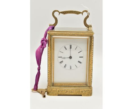 A LATE 19TH CENTURY AUGUSTE OF PARIS STRIKING BRASS CASED CARRIAGE CLOCK, the handle and case ornately engraved throughout wi