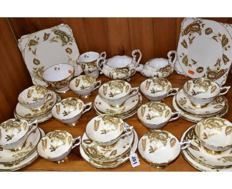 A FORTY TWO PIECE ROYAL STAFFORD TEA SET, decorated with gilt poppies on a cream ground, pattern no 8579, comprising two cake