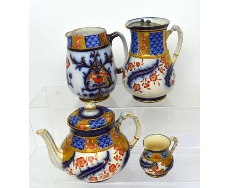 MacIntyre, Burslem; a four-piece tea service decorated in flow blue with applied gilding comprising teapot R.N.308932, hot wa