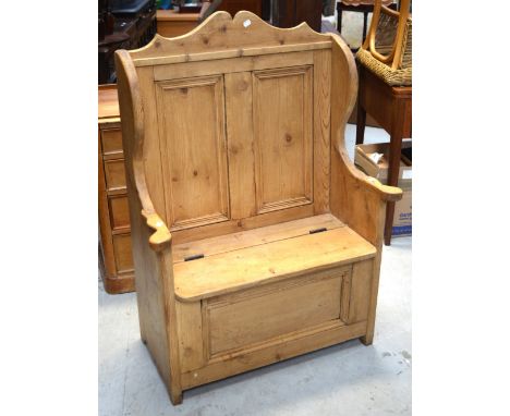 A small pine panel-back pew with hinged seat, length 78cm.