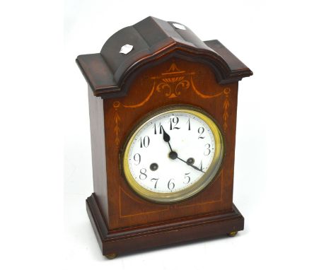 An early 20th century inlaid mahogany-cased bracket clock by Junghans, with brass chiming movement, circular enamel dial set 