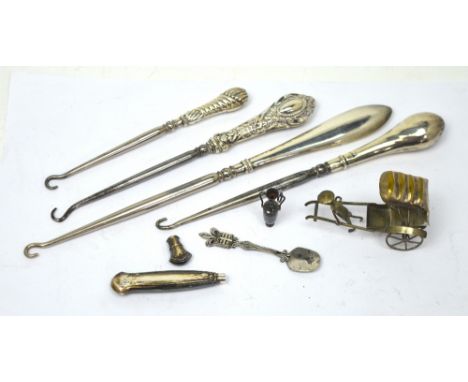 Four silver-handled button hooks, a white metal model of a rickshaw etc.