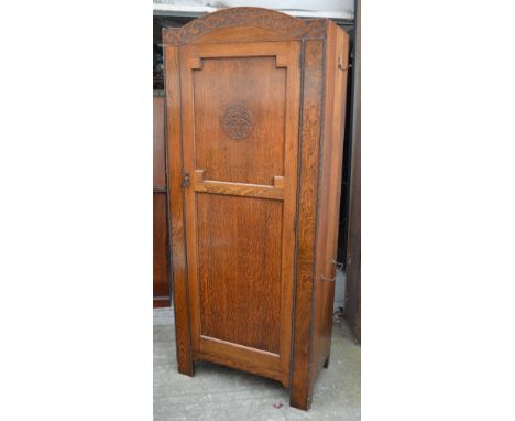 A 1920s oak hall robe, panelled with moulded cornice, interior with mirror, single shelf and hanging space, sides fitted with