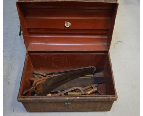A metal chest with a quantity of vintage tools to include saws, spanners and marine engineers' tools.