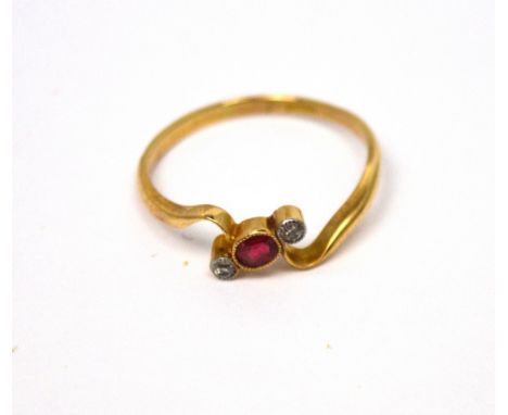 An 18ct gold ring set with small central ruby and tiny diamond to either side, size T, approx 2.85g.