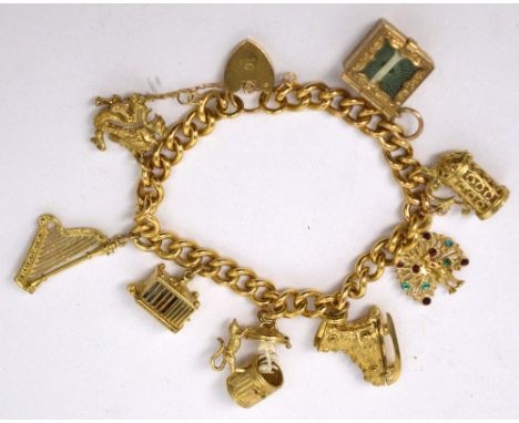 A 9ct gold charm bracelet set with eight charms to include an ice-skate, harp, a bone opening to reveal fish bones, dragon et