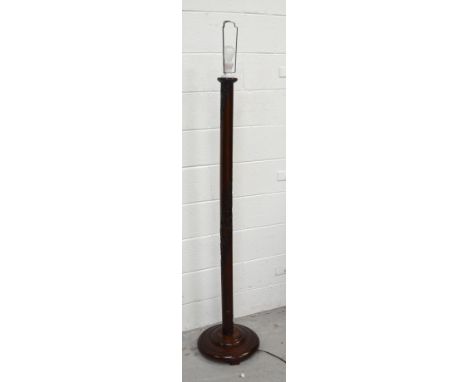 An Oriental carved wooden standard lamp.
