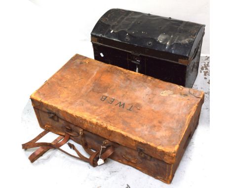 An early 20th century black metal dome-top travel trunk, length 59cm and an early 20th century brown leather suitcase initial