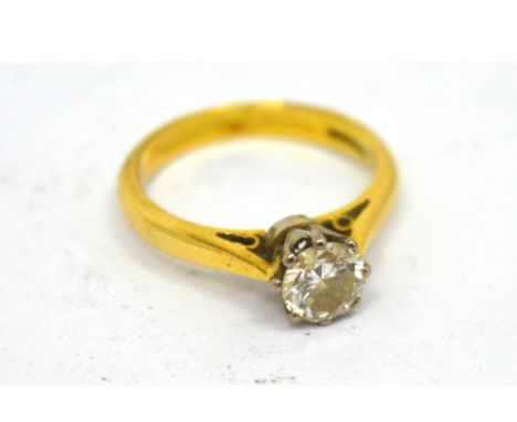 An 18ct yellow gold diamond solitaire ring, the round cut stone approx 0.5ct, in a claw setting, on pierced shoulders, size K